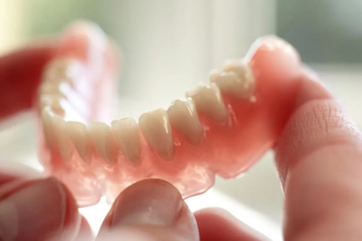 Desert Dental Spa patient holding their new dentures